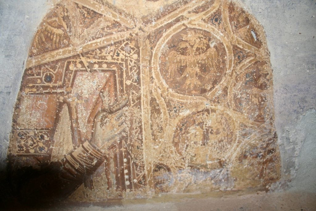 A close-up photograph of a 15th century fresco showing Emperor Constantine XI Palaiologos' cloak.