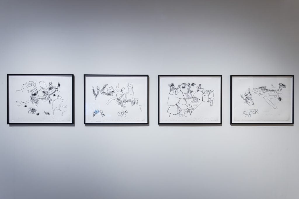 Framed abstract black-and-white line drawings hang on a white gallery wall, showcasing minimalist, geometric, and organic shapes in a modern art exhibition setting.