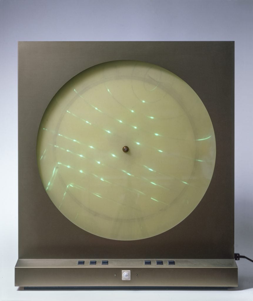 Presented by the Mayor Gallery in London, an early tech artwork by Davide boriani of a machine with a circular digital screen and various green lights like radar.