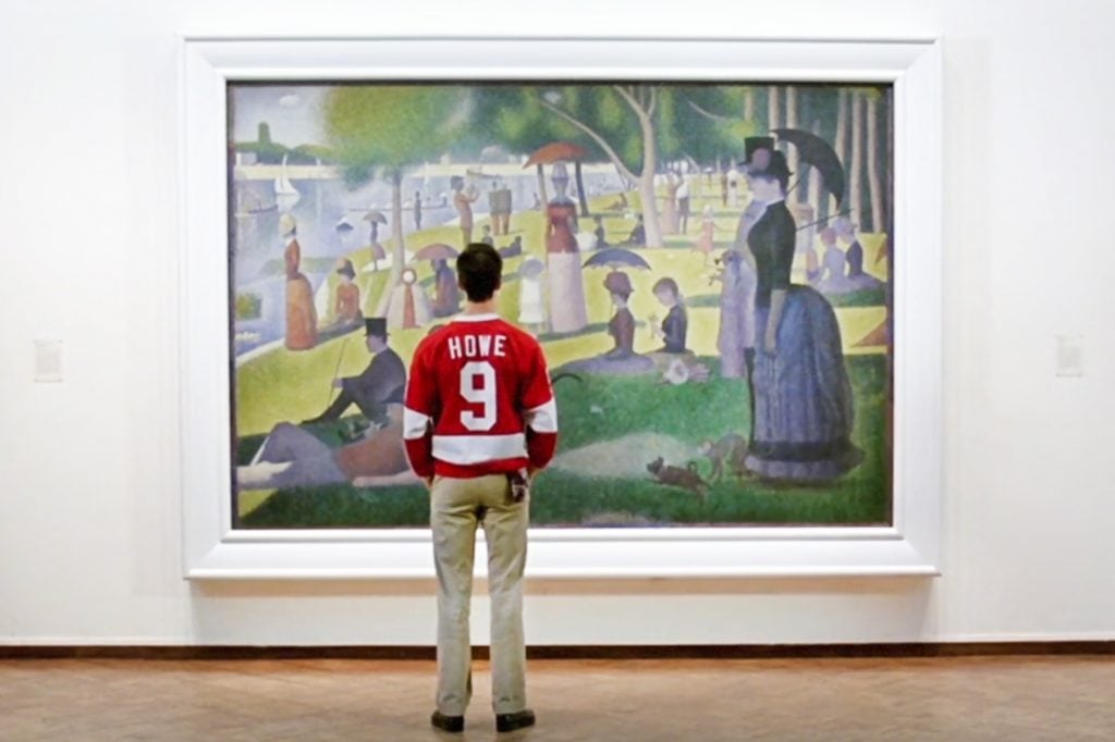 An image of Alan Ruck as Cameron Frye in Ferris Bueller's Day Off looking at Seurat's A Sunday Afternoon on the Island of La Grande Jatte.