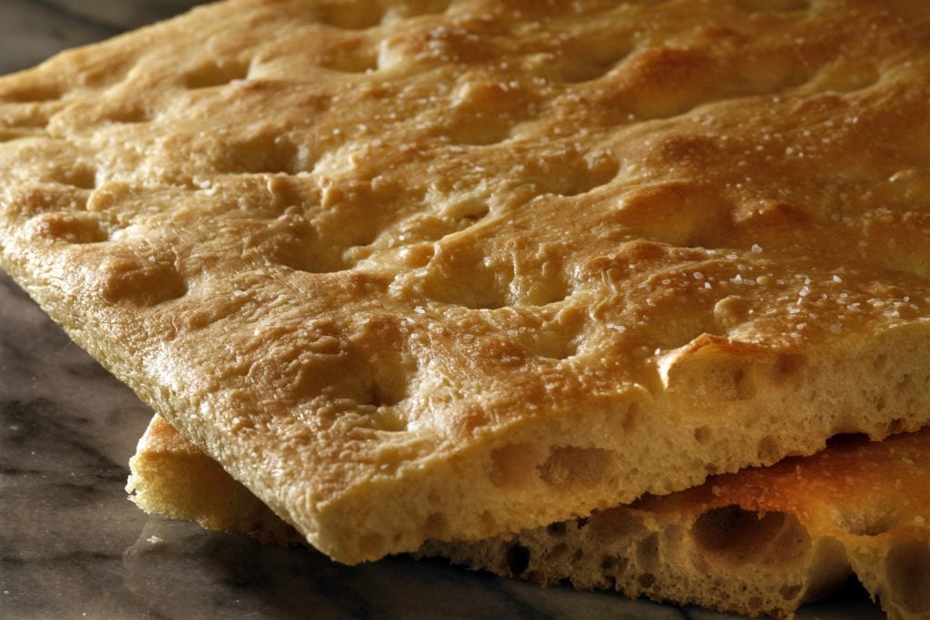 Close-up of two slices of focaccia bread rested on top of each other