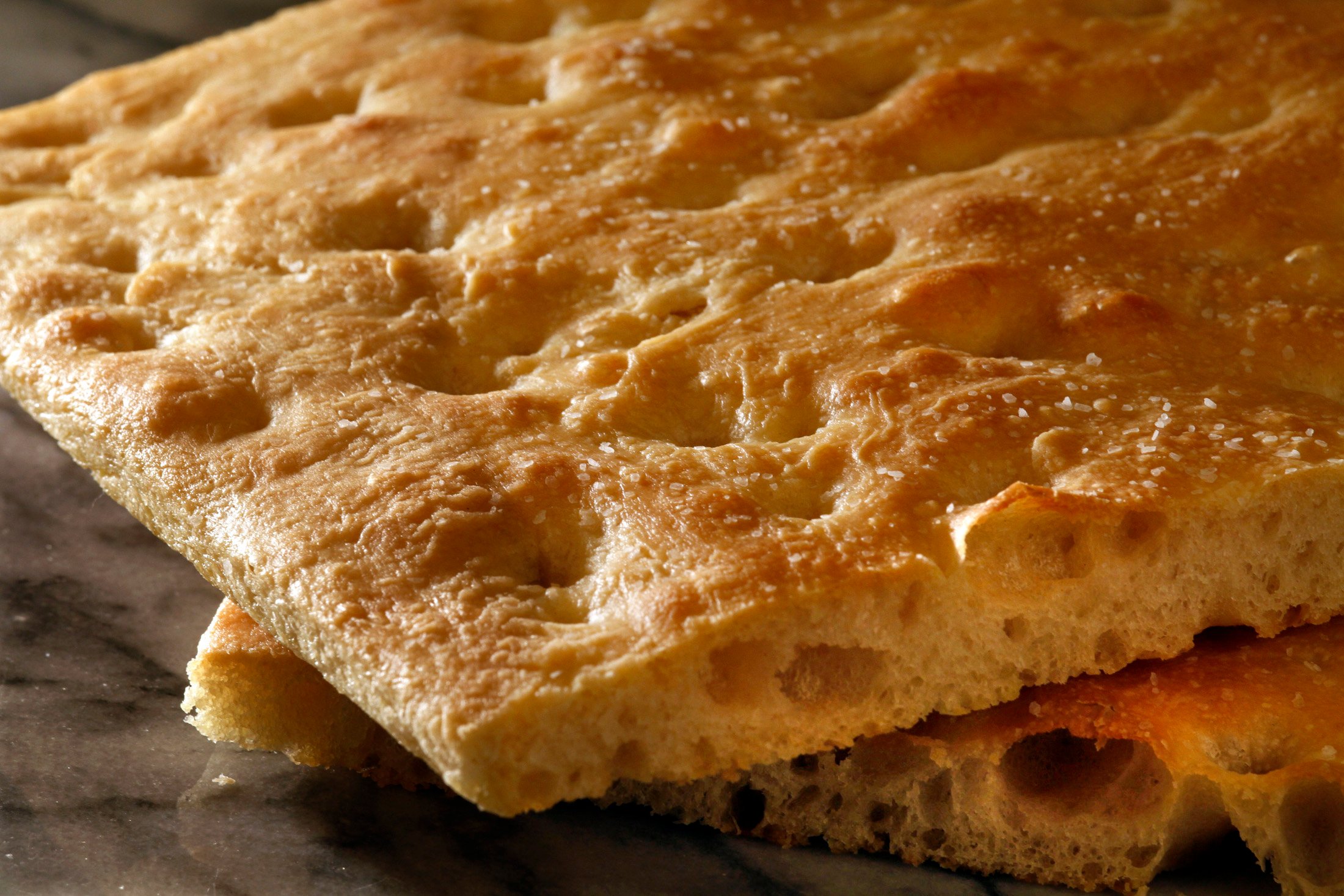 Close-up of two slices of focaccia bread rested on top of each other