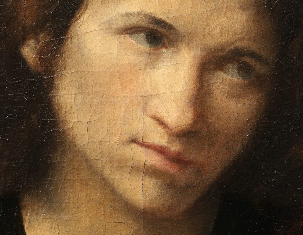 Close-up of a painting of a young man's thoughtful face