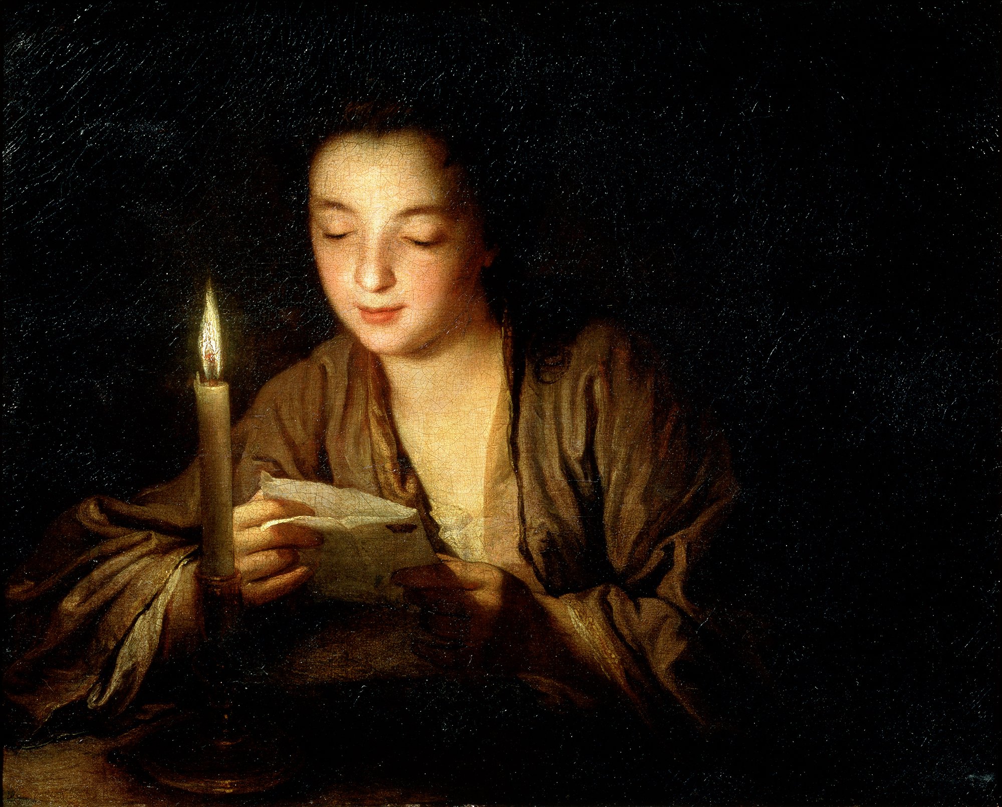 A girl reads a letter by candlelight in this painting.