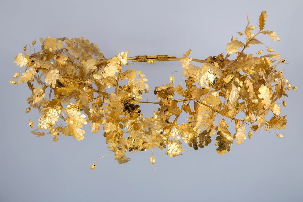 a gold wreath on a plain white background