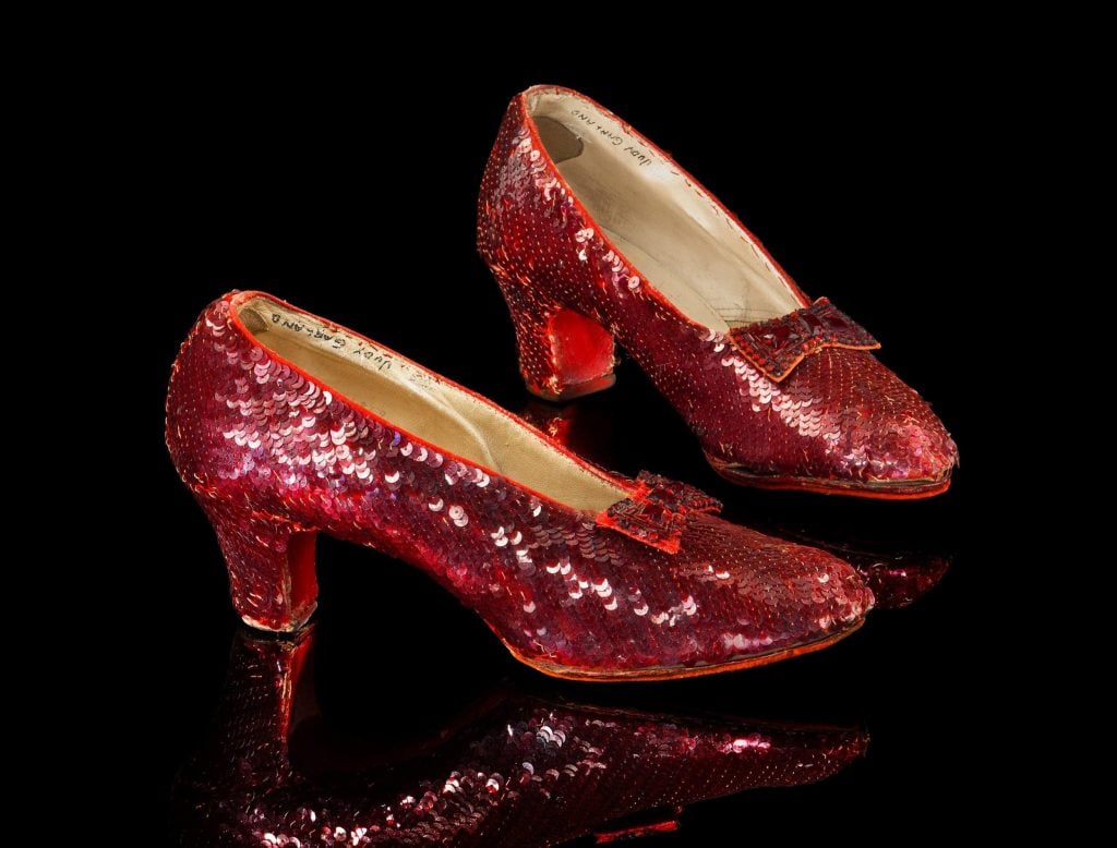 The Ruby Slippers from The Wizard of Oz, photographed on a black background.