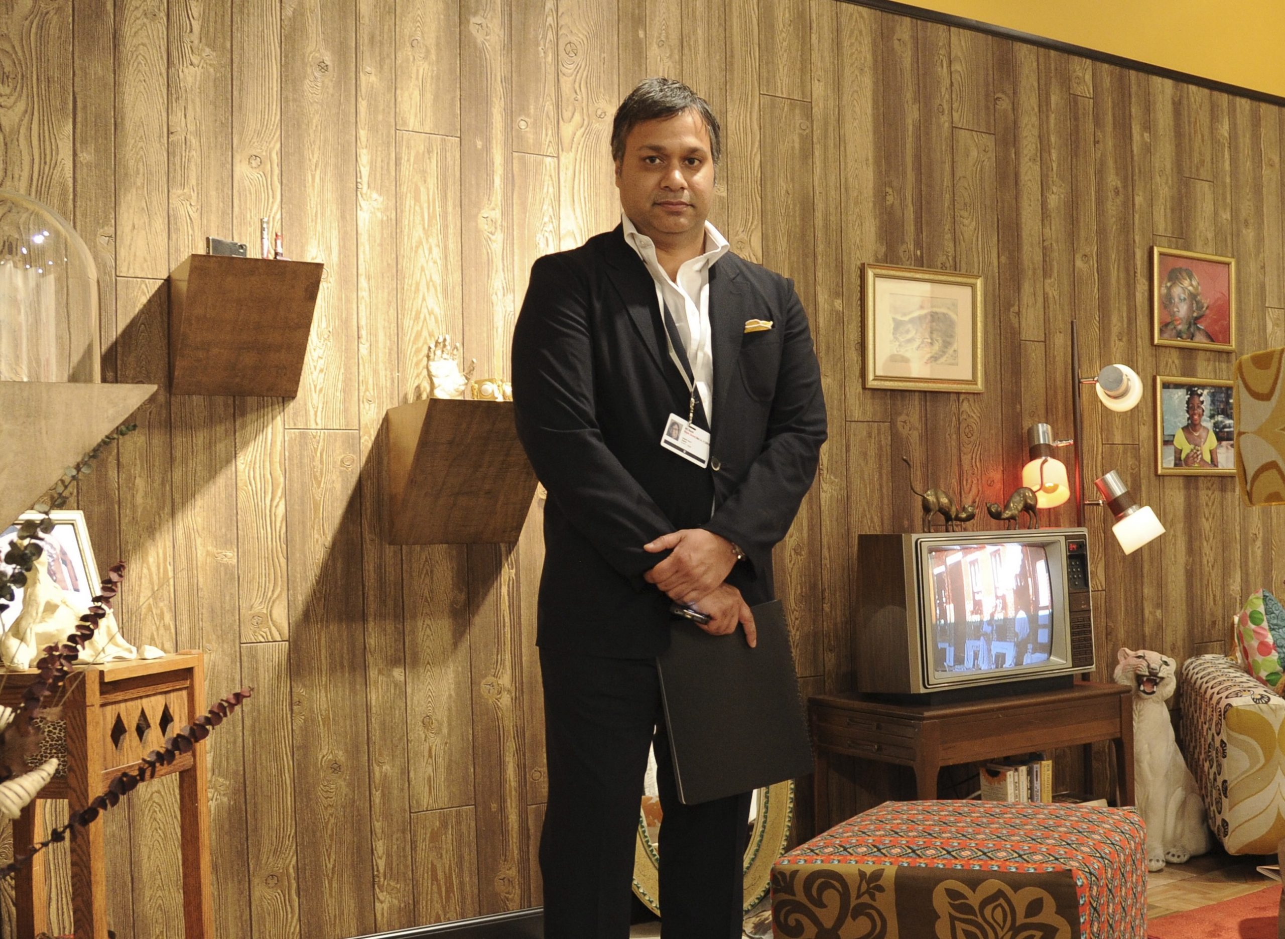 Indian-American art dealer Kavi Gupta stands in his booth at an art fair