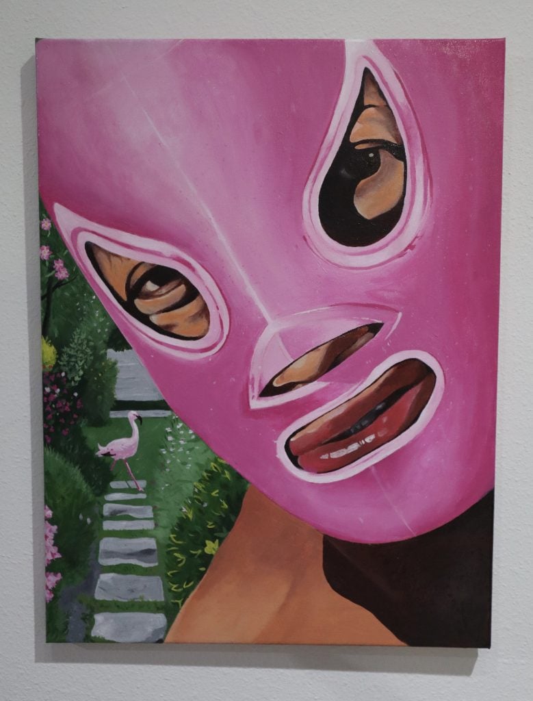 One of professional wrestler Lee Moriarty's lucha libre paintings shown by Orange Crush at NADA Miami Beach. It is a closely cropped painting of the head of a wrestler wearing a pink luchador mask. 