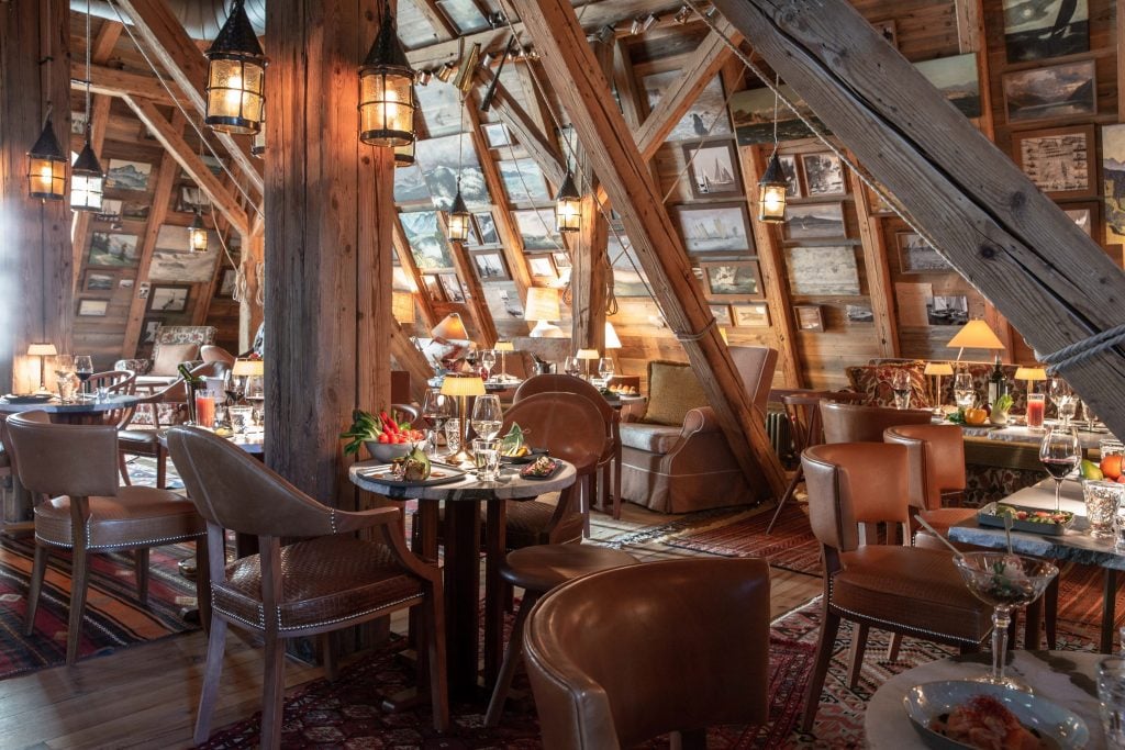 a wooden beamed dining room is covered in art pieces 