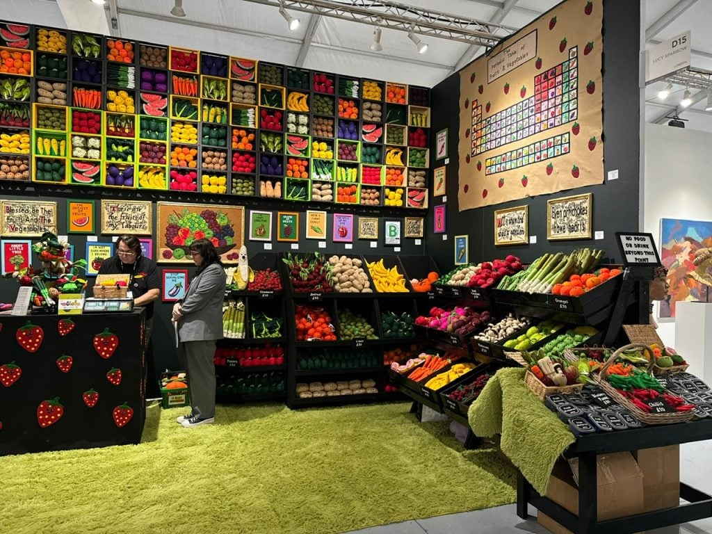 Lucy Sparrow's "Blessed Be the Fruit" installation at the SCOPE Art Show in Miami Beach. It is a fruit and vegetable market where everything is made of stuffed felt sculptures. 