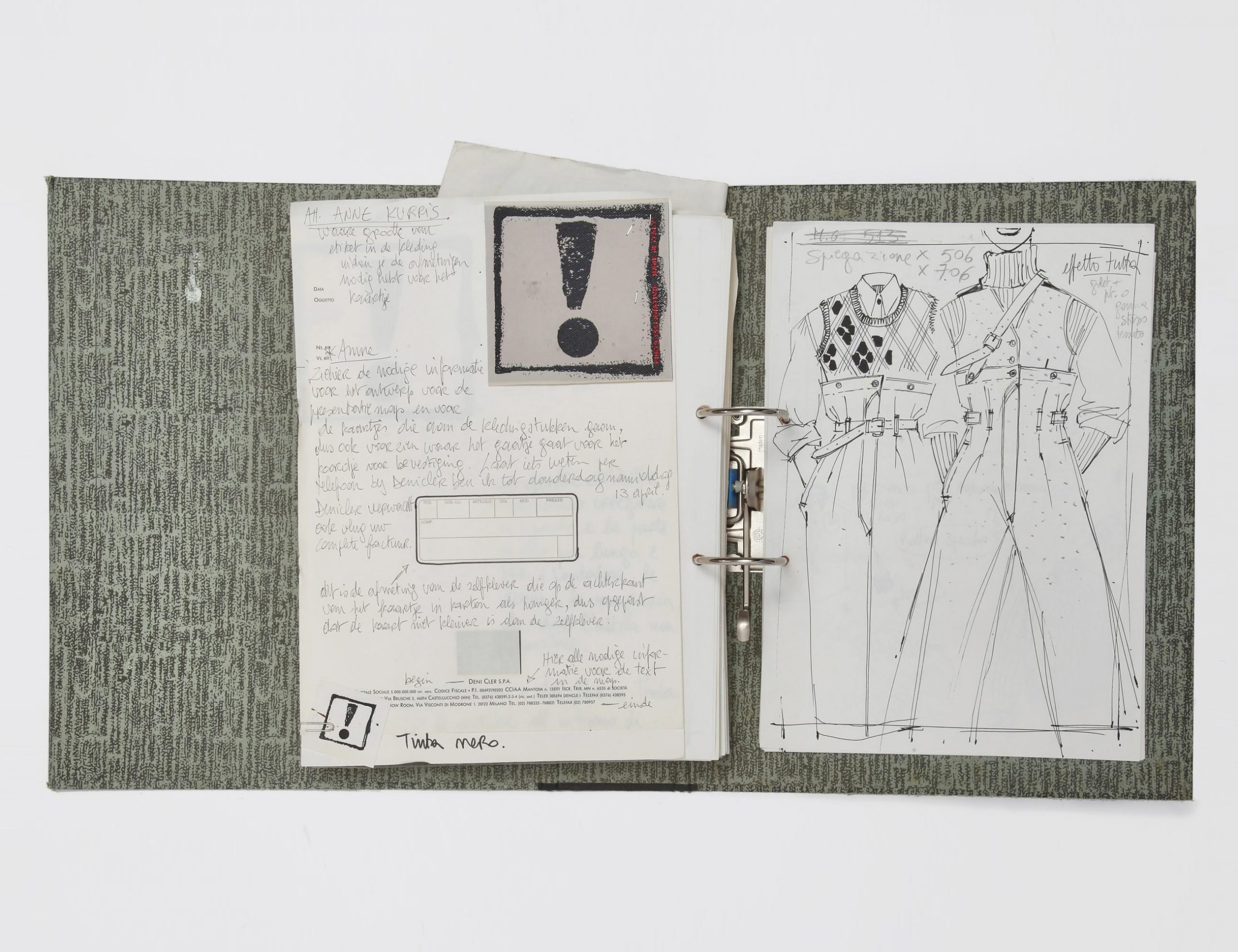 A photograph depicting an open gray patterned binder filled with fashion sketches, as seen against a white background.