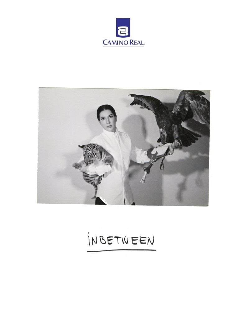 A photo of Marina Abramović holding a bird and a tiger is pasted on hotel stationery with the handwritten phrase "Inbetween"