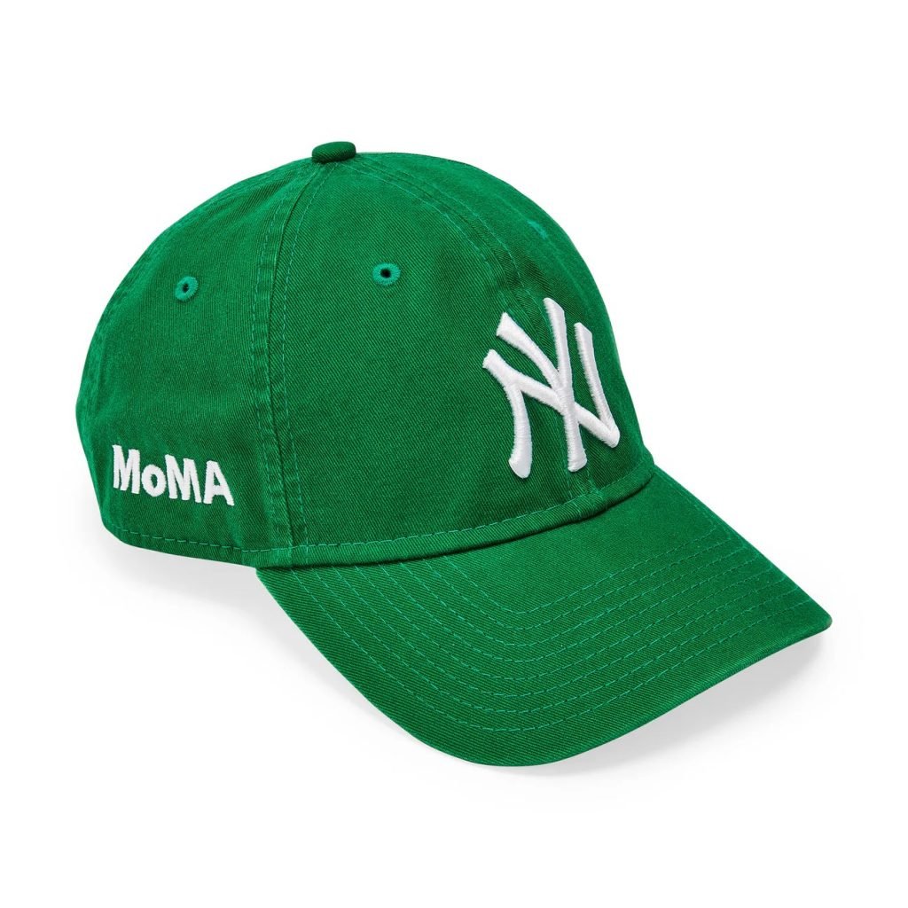 a green baseball cap with a yankees logo and the moma logo