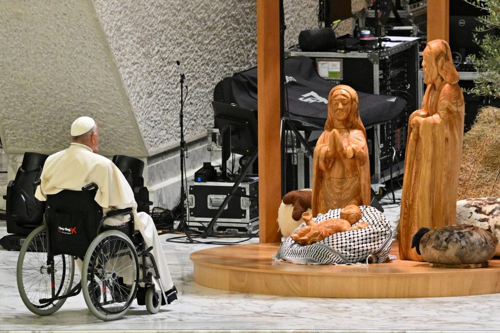 Pope Francis prays before the "Nativity of Bethlehem 2024" during its inauguration in the Paul VI Hall, during the private audience to donors of the Nativity Scene and the lighting of the Christmas tree ceremony at St Peter's Square in the Paul-VI hall at the Vatican on December 7, 2024.