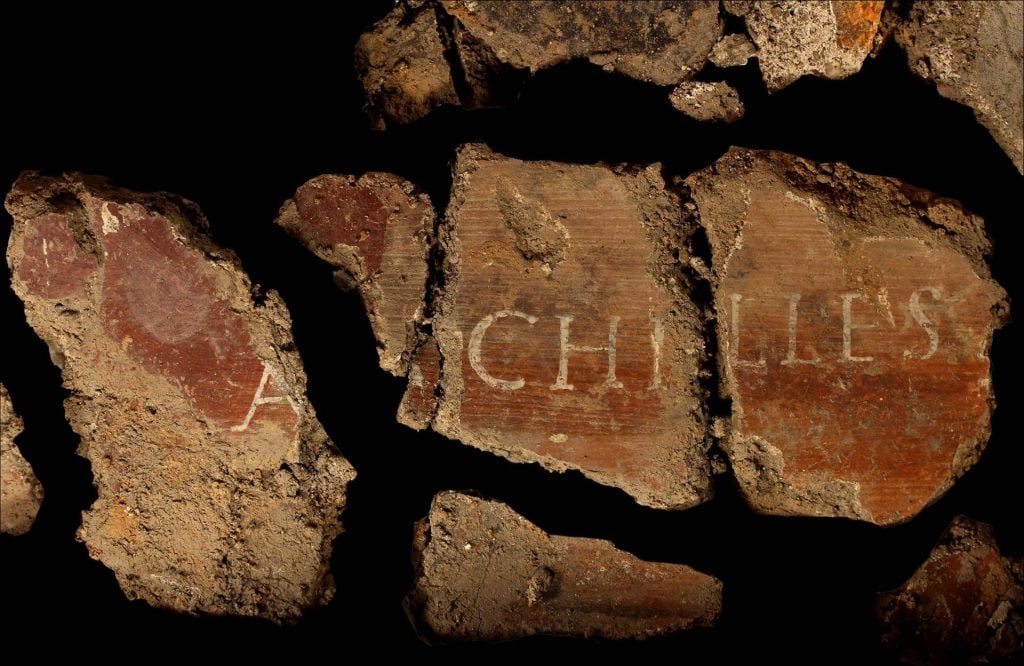 Fragments of an ancient fresco, aligned to form the word "Achilles"