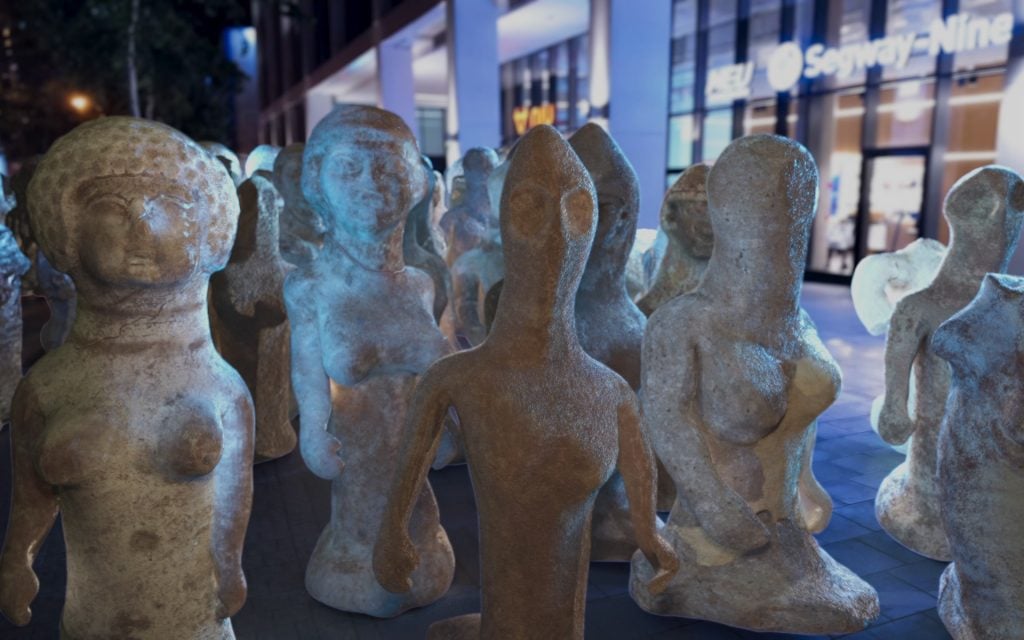 A digital image showing a number of ancient figurines marching together