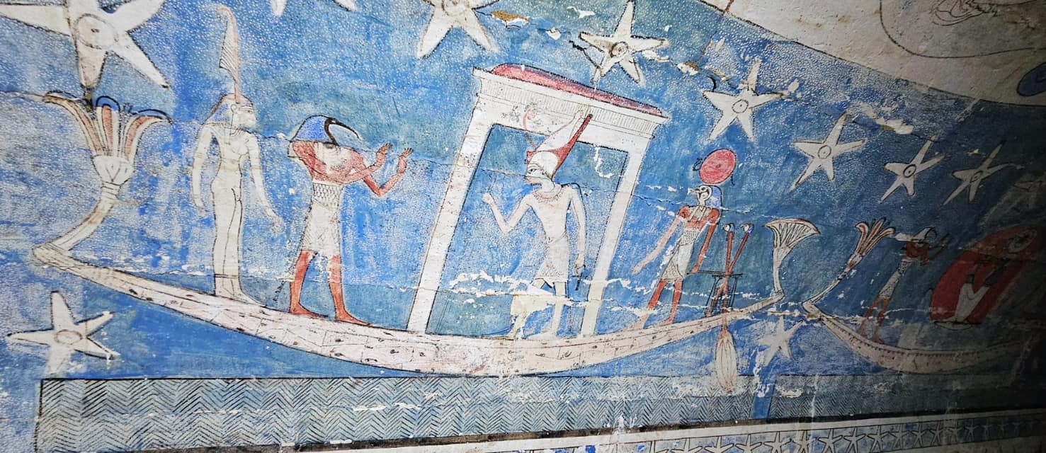 wall painting with blue background shows Egyptian boat of the dead