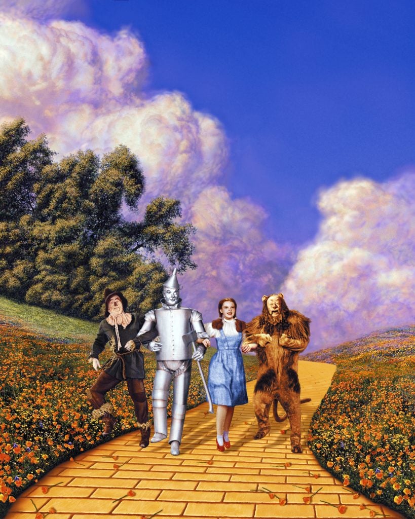 Actors Ray Bolger (1904–1987), Jack Haley (1897–1979), Judy Garland (1922–1969) and Bert Lahr (1895–1967) in costume on the Yellow Brick Road in a scene from the film The Wizard of Oz (1939).