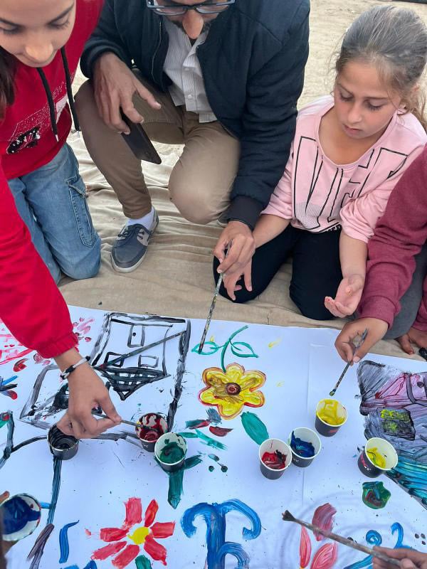 Palestinian children in Gaza paint during an art therapy session