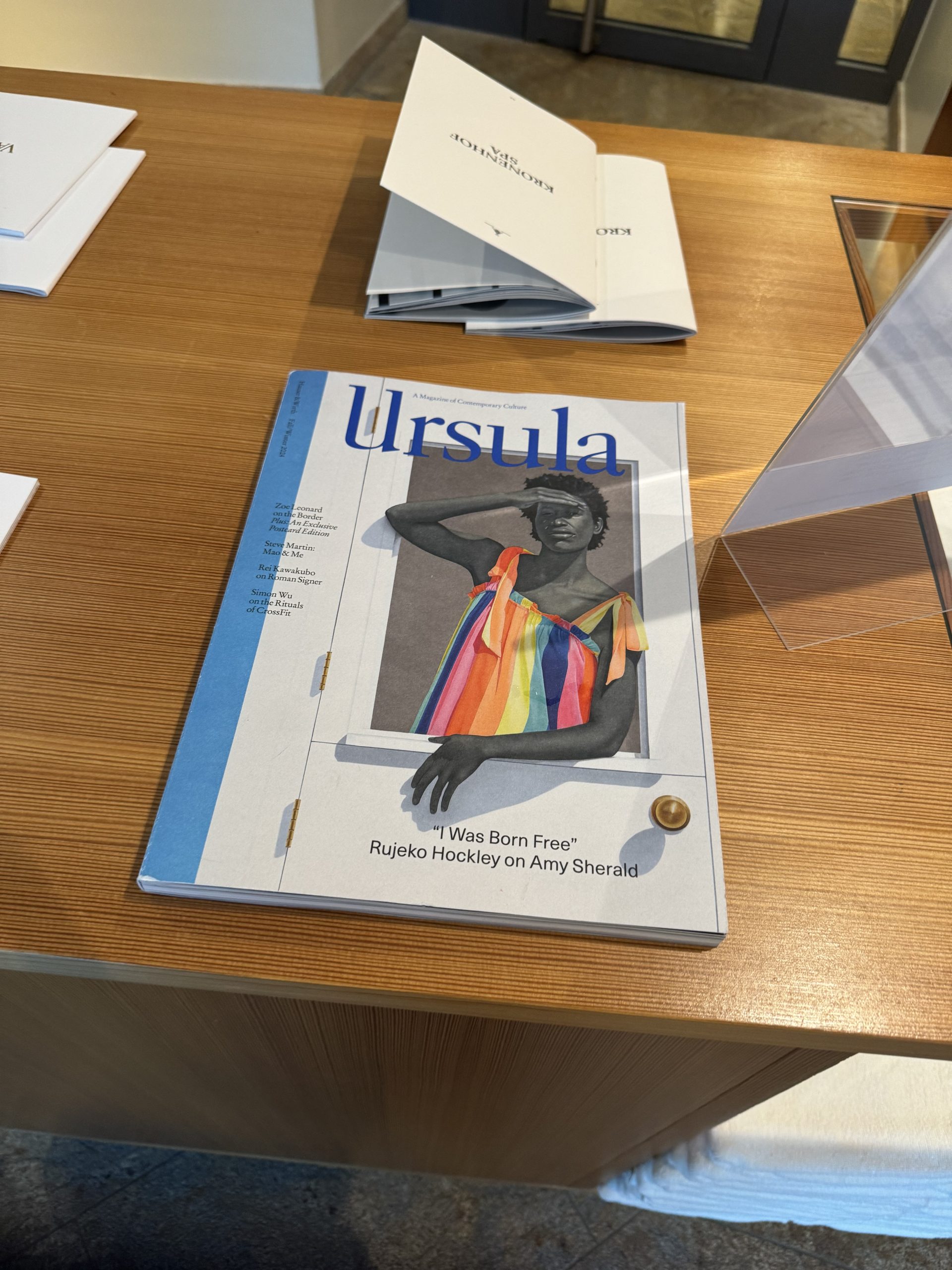 Ursula magazine sits on a wooden table