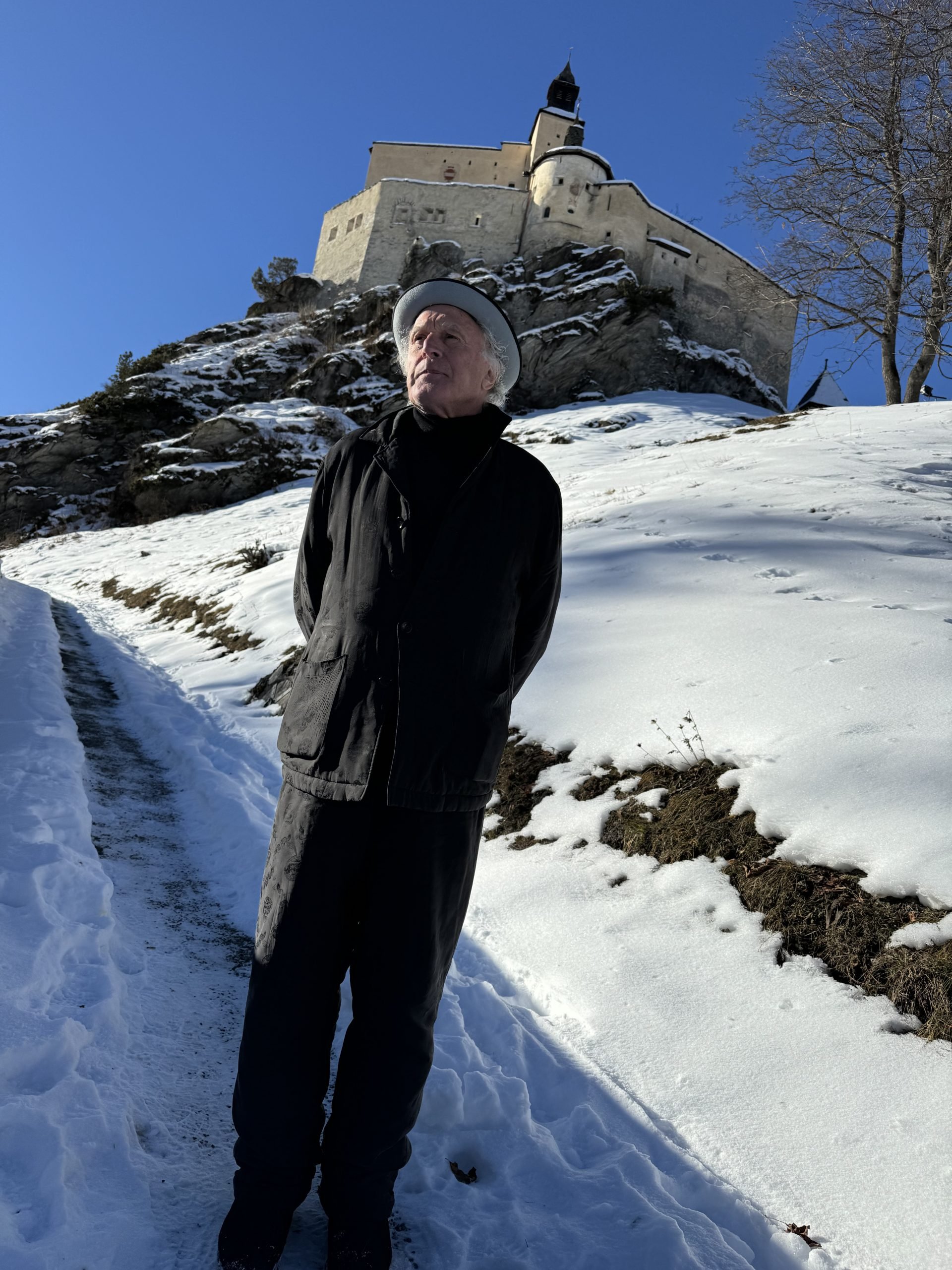 A man stands outside a castle