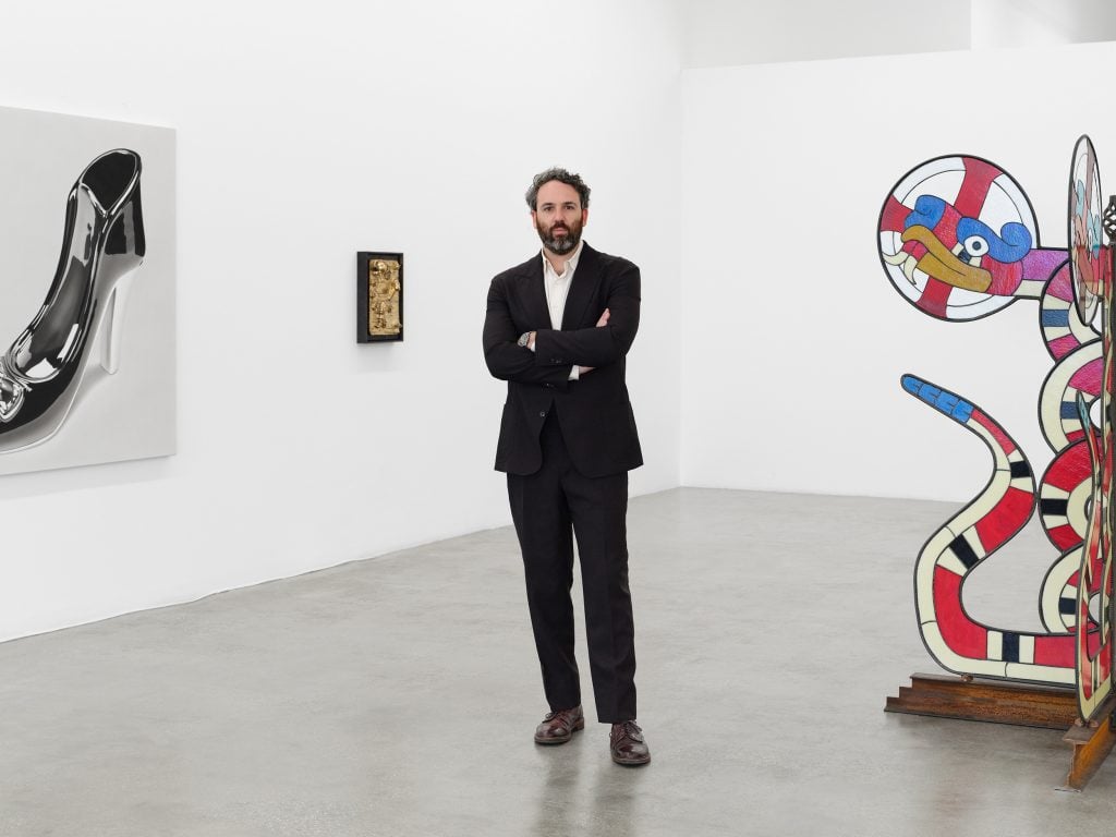 an image of a man in a suit in an art gallery