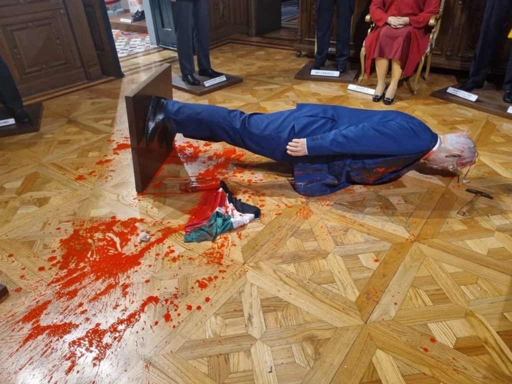 Netanyahu wax sculpture is seen on the floor after it was attacked by a hammer