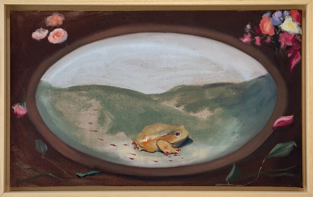 A vibrant frog rests within an oversized dish, surrounded by bloodied footprints