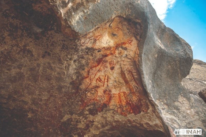 The cave painting of a hand that was removed by looters is seen before it was stolen