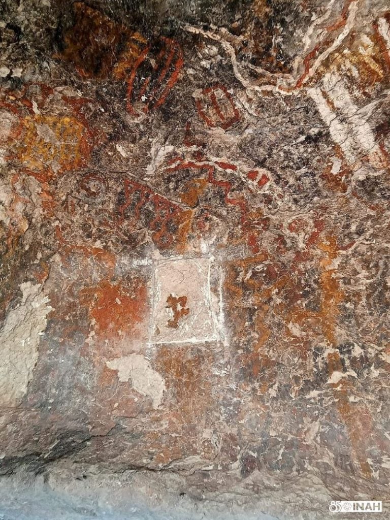 Damage to the cave wall where a panel of ancient art sits is pictured