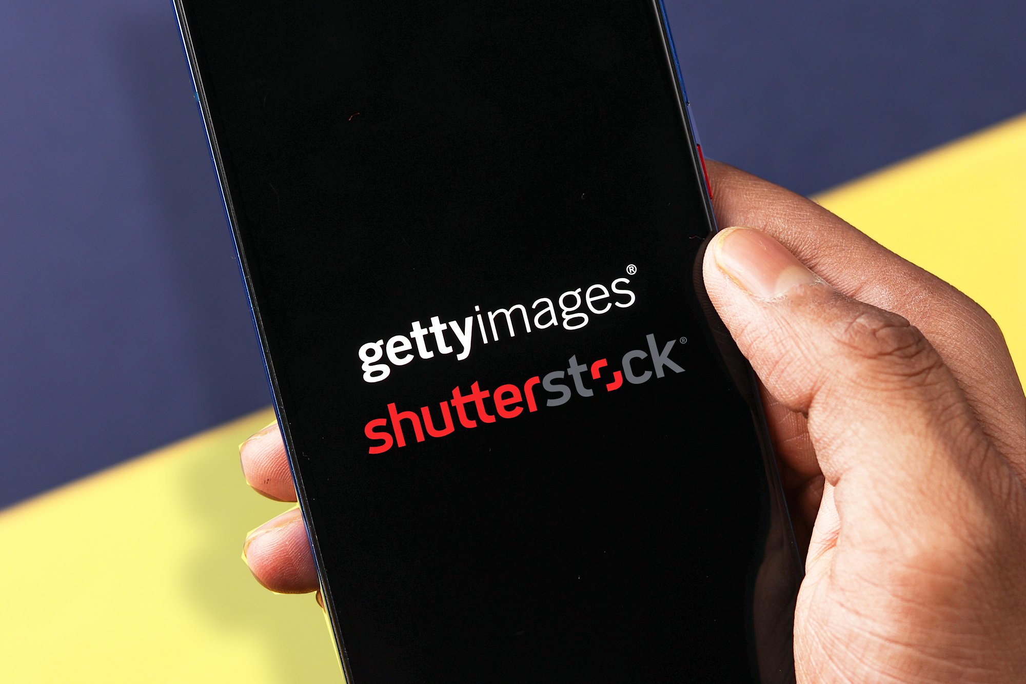 An image of Getty Images and Shutterstock logos on a smart phone