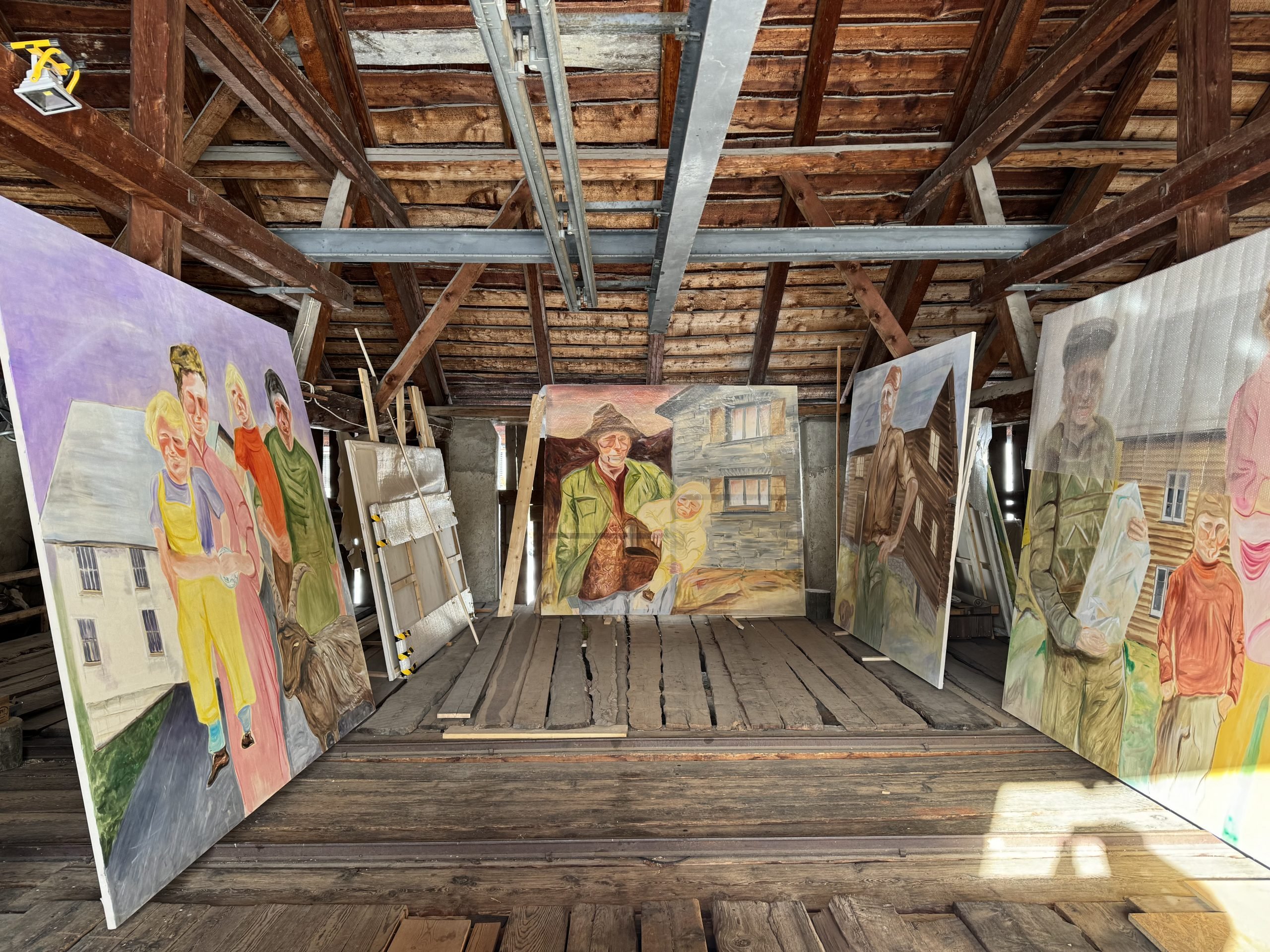 Paintings fill a rustic studio