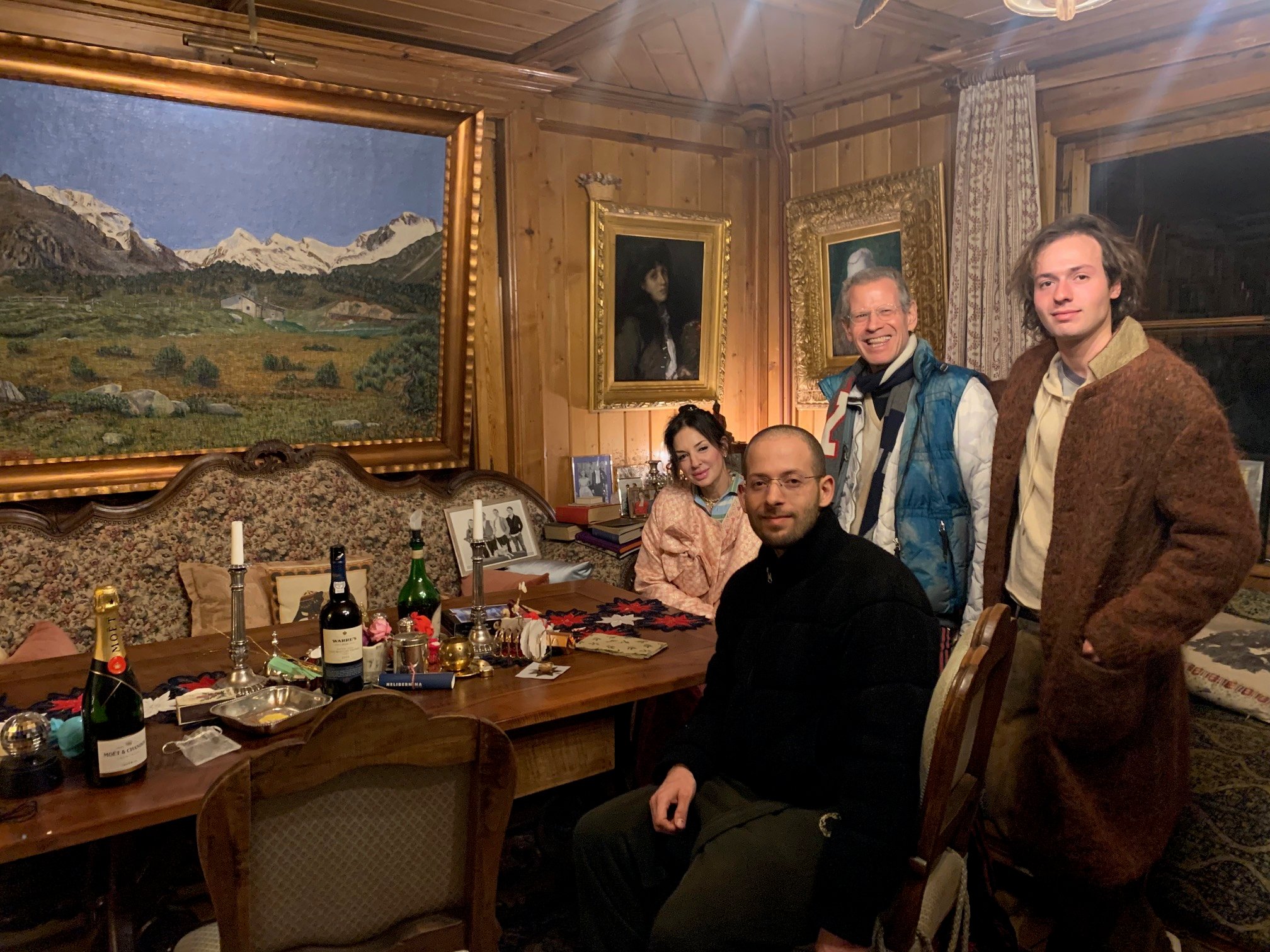 People pose in a wood-paneled room