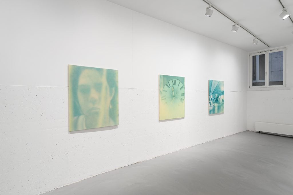 Installation view of "Make Me See" exhibition at Enari Gallery showing three pastel tonal green paintings installed on a white wall.