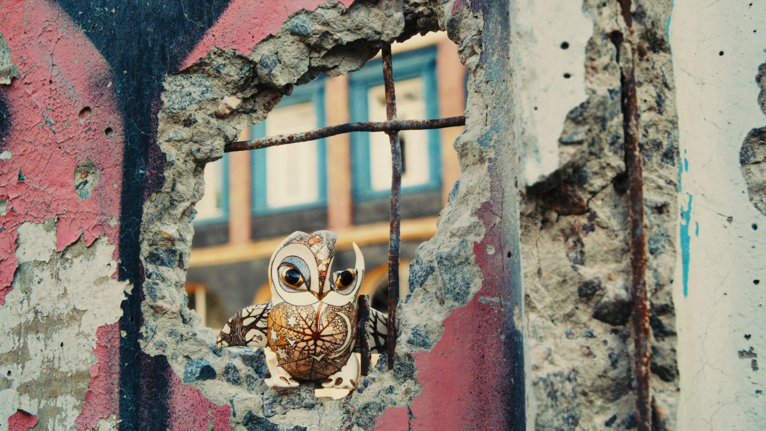 A tiny owl created by artists Slava Leontyev and Anya Stasenko perches in a partially destroyed wall in the film Porcelain War