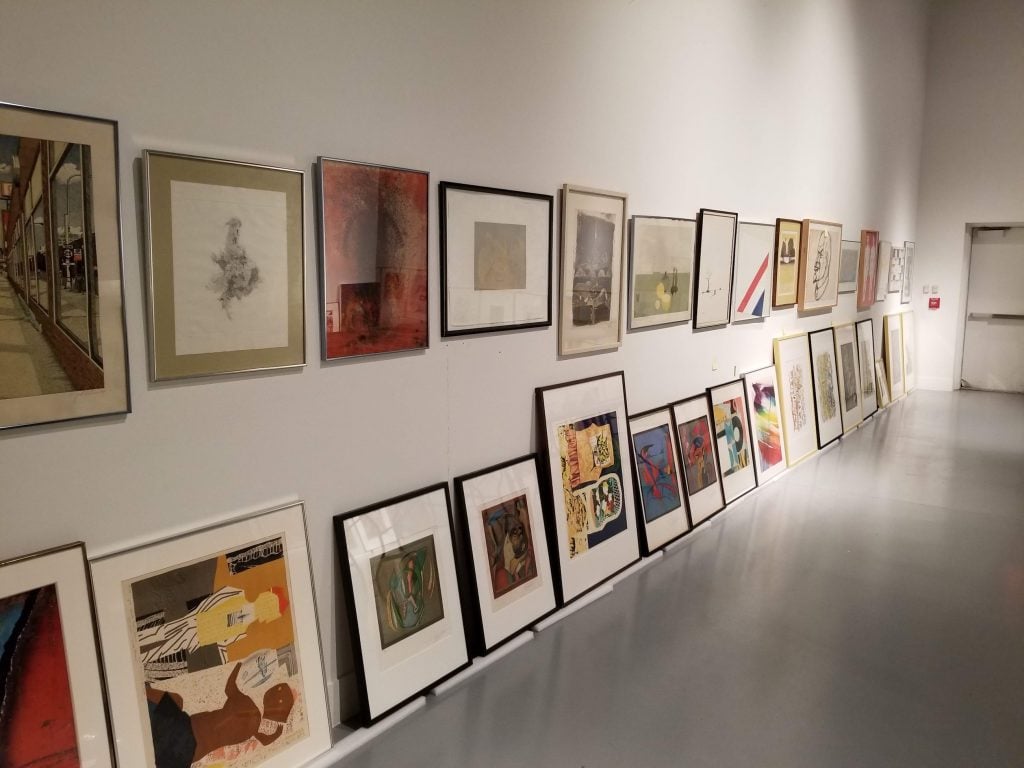 Framed artworks from the Freedman Gallery art collection at Albright College lined up along a gallery wall before the controversial art auction and deaccessioning sale.