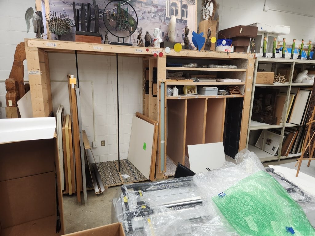 Empty art storage racks at Freedman Gallery, Albright College, showing removed artworks and disorganized space before the college's controversial art collection auction.