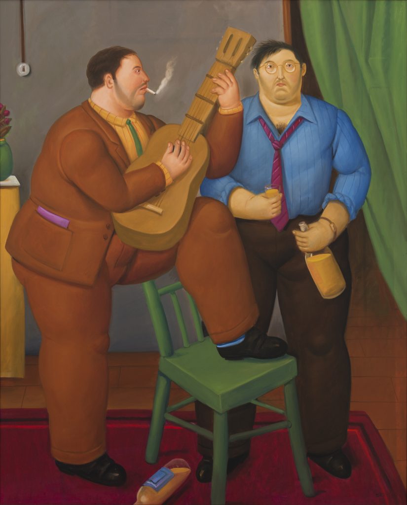 A painting by Fernando Botero titled Two Friends (2012), depicting two plump men in Botero's signature voluminous style. One man, dressed in a brown suit, is seated on a green chair playing a guitar and smoking a cigarette, while the other, wearing a blue shirt and red tie, stands beside him holding a drink and a bottle. A bottle lies on the floor, and a green curtain drapes in the background, evoking an intimate, slightly humorous domestic scene. Presented at Intersect Aspen.
