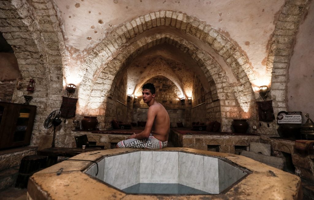 Inside the Hammam al-Samra, Gaza’s only functioning Ottoman-era bathhouse, showing its arched stone ceiling and central fountain.