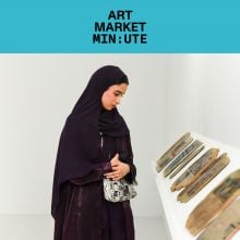Woman viewing contemporary art objects displayed on a white shelf at an exhibition, featured in Art Market Minute, highlighting Middle Eastern art and modern collecting trends.
