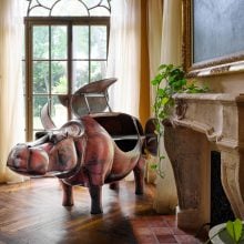 a room with a window and a hippo that is a bar cart