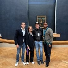 four people in front of the Mona Lisa