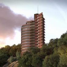Tall red terraced residential tower rises from forested hillside beneath dramatic pink and purple clouds.