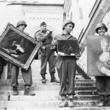 Monuments Men soldiers carry recovered paintings down Neuschwanstein Castle steps after seizing Nazi-looted art.