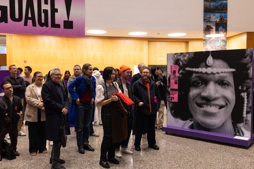 a crowd attends an exhibition opening at the Brooklyn Public Library's central branch