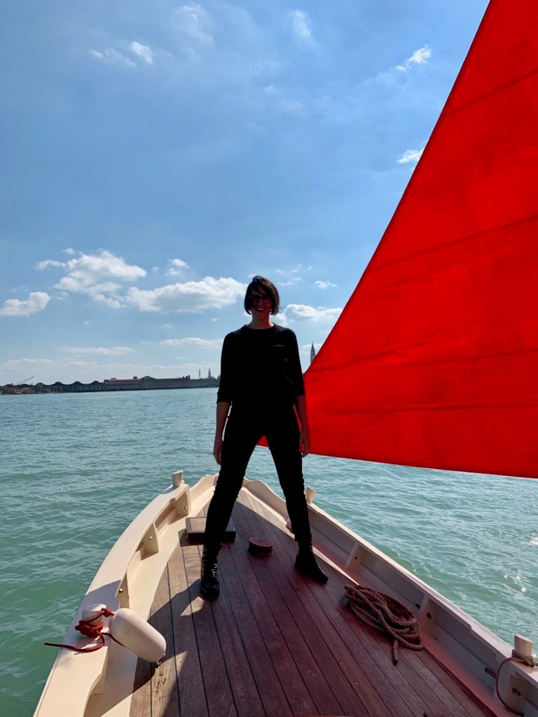 Melissa McGill with one of the boats for her project Red Regatta. Photo by Sarah Cascone.