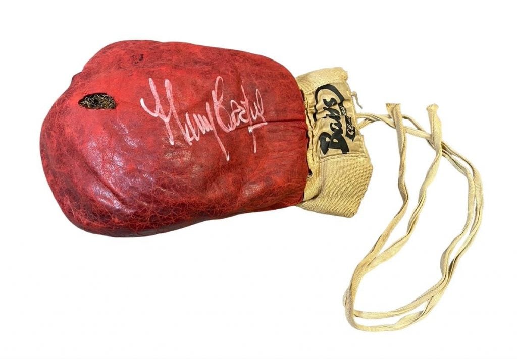 a signed cerise colored leather boxing glove signed by boxer Henry Coopers