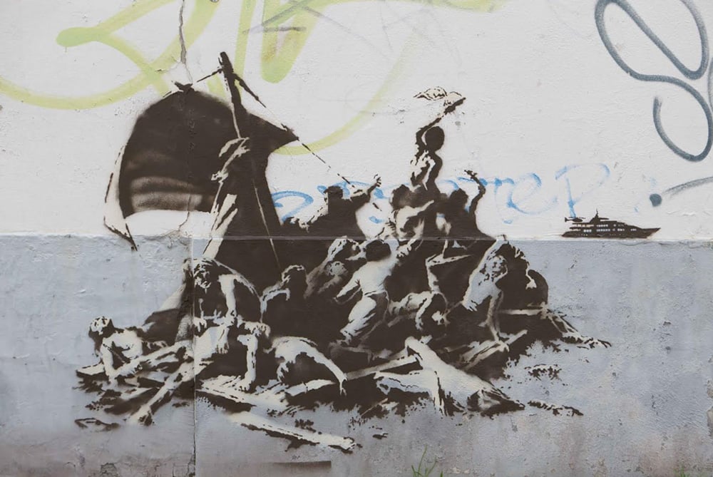 Banksy work in Calais 'Jungle' shows Steve Jobs as migrant Banksy-calais-raft