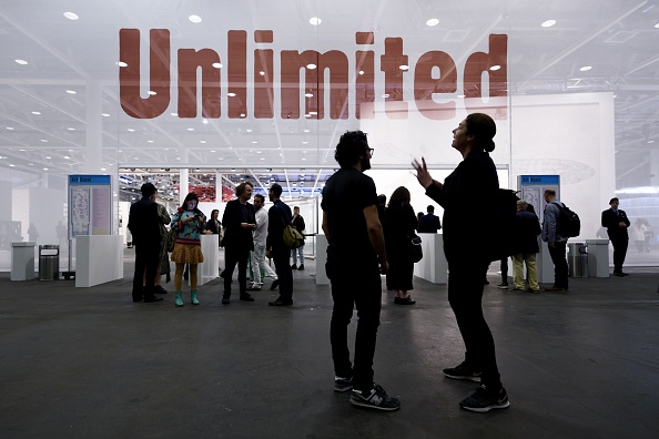 Visitors speak in front of the entrance of Unlimited at Art Basel. June 14, 2016. Image: Fabrice Coffrini/AFP/Getty Images.